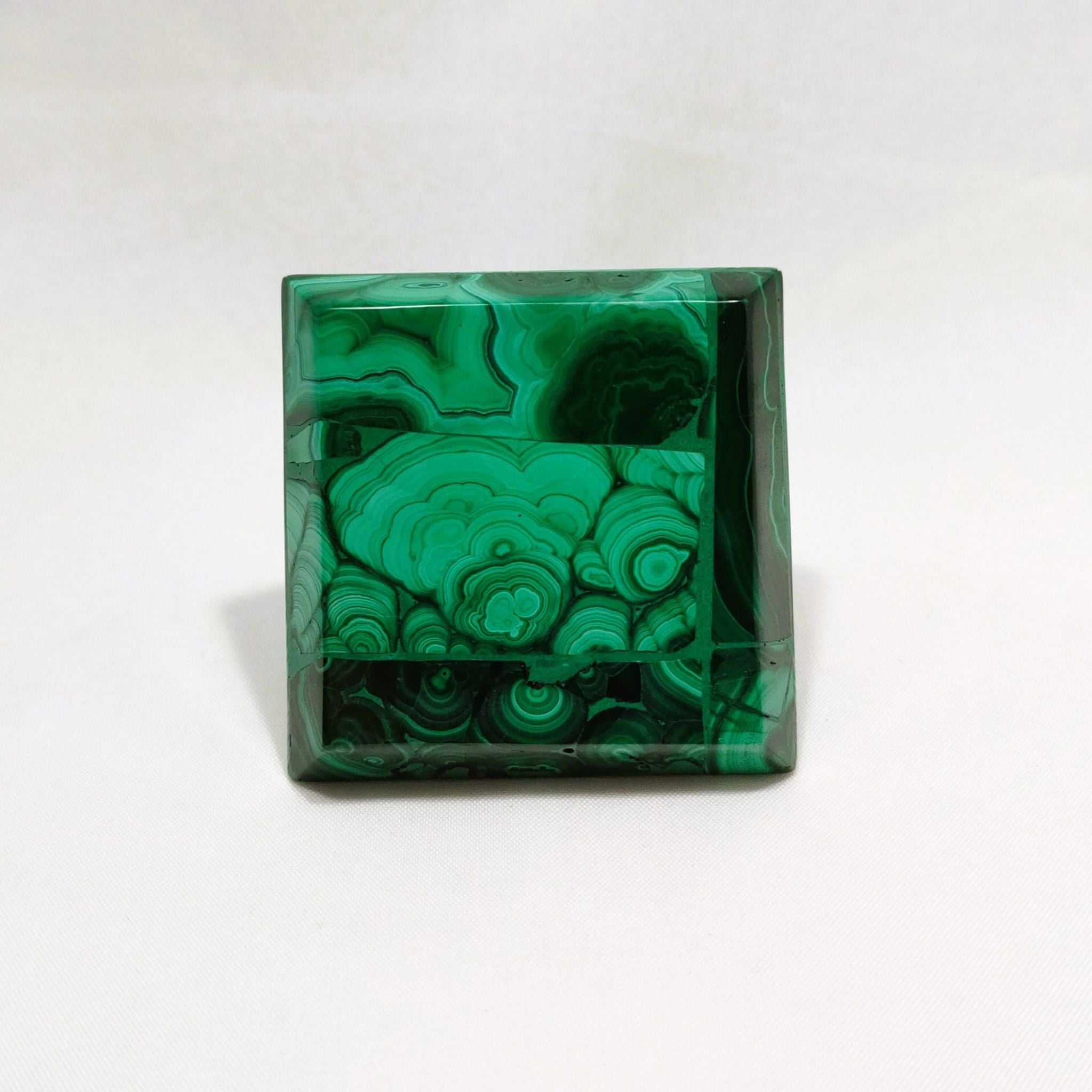 Bottom view of handcrafted pyramid, made with malachite.