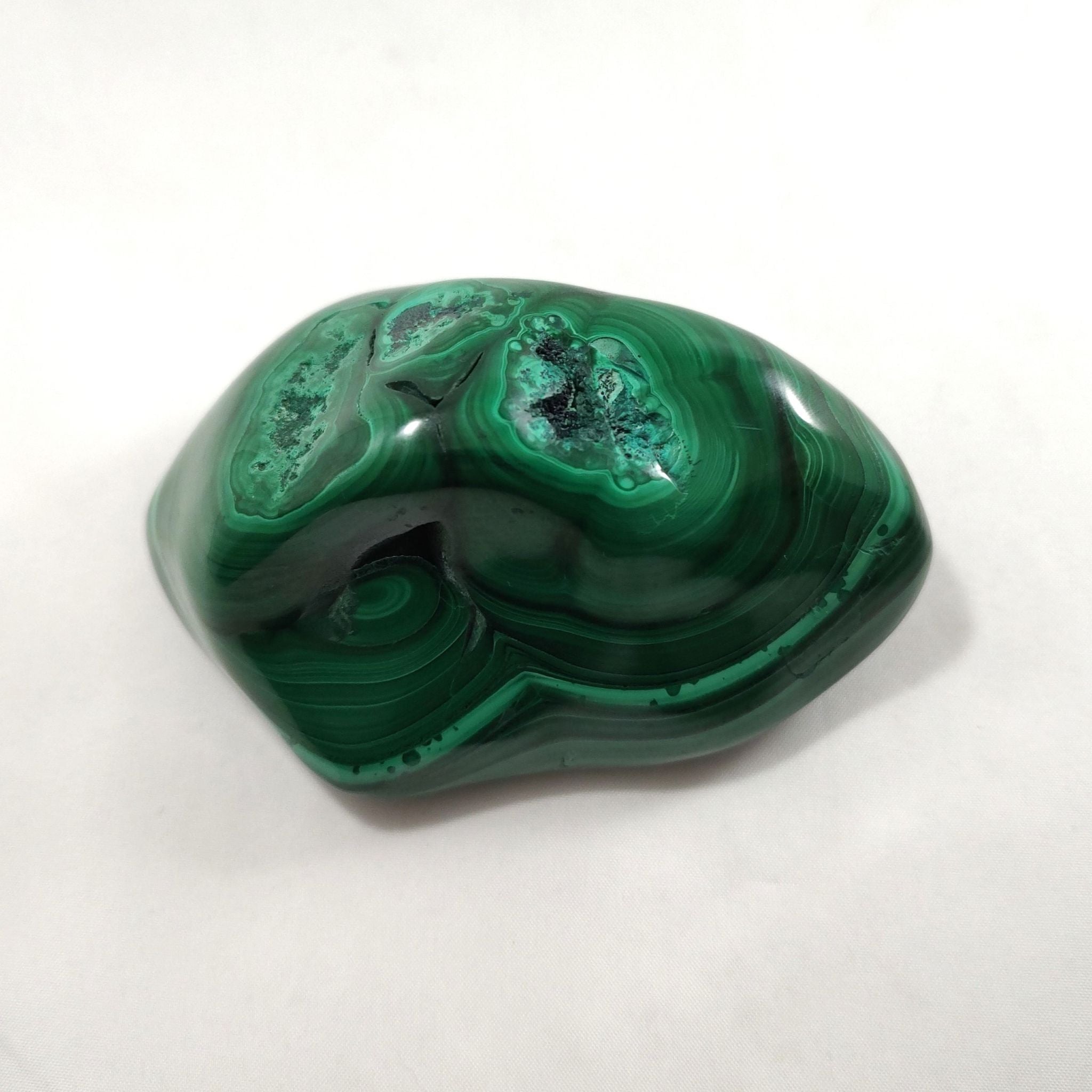 Back and side of malachite crystal freeform carving